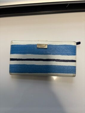 Kate Spade New York Blue, Navy & White Striped Wallet with Gold Logo showing wea